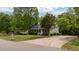 Traditional home with a curved driveway, surrounded by mature trees and landscaping at 160 Fox Run Rd, Youngsville, NC 27596