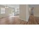 Open-concept kitchen and dining area filled with natural light and featuring wood laminate floors at 160 Fox Run Rd, Youngsville, NC 27596