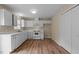 Bright kitchen with white cabinetry, appliances, and wood-look flooring at 160 Fox Run Rd, Youngsville, NC 27596
