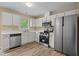 Modern kitchen with stainless steel appliances, white cabinets, and hardwood style floors at 160 Fox Run Rd, Youngsville, NC 27596