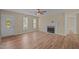 Spacious living room featuring a fireplace, ceiling fan, and multiple windows at 160 Fox Run Rd, Youngsville, NC 27596