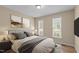 Comfortable bedroom featuring stylish decor, neutral tones and wood flooring at 160 Fox Run Rd, Youngsville, NC 27596