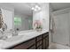 Bathroom featuring double sink vanity, a large mirror, and a glass enclosed shower at 162 W Lumber Ct, Clayton, NC 27520
