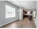 Open dining area with wood floors, large windows, and view into the kitchen with dark wood cabinets at 162 W Lumber Ct, Clayton, NC 27520