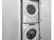 Laundry area with stacked washer and dryer at 162 W Lumber Ct, Clayton, NC 27520