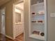 Hallway with built-in shelves leading to a bright bathroom with vanity at 1708 S Alston Ave, Durham, NC 27707