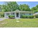 Charming one-story home with a well-manicured lawn and mature trees creating a welcoming curb appeal at 1708 S Alston Ave, Durham, NC 27707