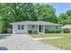 Well-maintained single-story home with updated siding and a gravel driveway complementing the green lawn at 1708 S Alston Ave, Durham, NC 27707