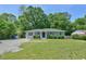 Traditional ranch home with a green yard, gravel driveway and mature trees at 1708 S Alston Ave, Durham, NC 27707
