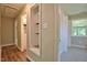 Well-lit hallway with carpet and shelf to additional rooms at 1708 S Alston Ave, Durham, NC 27707