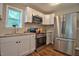 Modern kitchen features stainless steel appliances, sleek white cabinetry, and durable countertops, perfect for cooking and entertaining at 1708 S Alston Ave, Durham, NC 27707