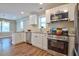 Well-equipped kitchen boasting stainless steel appliances, white cabinetry, and plenty of counter space, designed for culinary enthusiasts at 1708 S Alston Ave, Durham, NC 27707