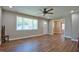 Sunlit living room with hardwood flooring, a large window, and access to other rooms in the house at 1708 S Alston Ave, Durham, NC 27707