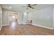Spacious living room with hardwood floors, fresh paint, and a ceiling fan, creating a welcoming and bright atmosphere at 1708 S Alston Ave, Durham, NC 27707