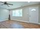 Bright living area featuring hardwood floors, a ceiling fan, and a view of the front yard through a large window at 1708 S Alston Ave, Durham, NC 27707