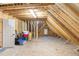 Unfinished attic space with exposed beams and a small window at 1710 Eddy Ct, Franklinton, NC 27525