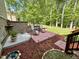 Cozy patio perfect for outdoor dining with a red brick design and a serene garden view at 1710 Eddy Ct, Franklinton, NC 27525