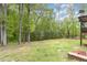 Large backyard with mature trees and a lush lawn at 1710 Eddy Ct, Franklinton, NC 27525