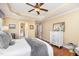 Relaxing main bedroom features a tray ceiling, windows with blinds, hardwood floors, and ensuite bath access at 1710 Eddy Ct, Franklinton, NC 27525