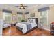 This primary bedroom features a tray ceiling, plantation shutters, ceiling fan, and hardwood floors at 1710 Eddy Ct, Franklinton, NC 27525