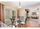 Cozy dining area with a glass table and sliding doors for outdoor access, next to the living room at 1710 Eddy Ct, Franklinton, NC 27525