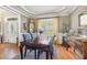Elegant dining room with a large wooden table, ornate chairs, and decorative window treatments at 1710 Eddy Ct, Franklinton, NC 27525