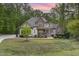 Beautiful home with a mix of stone and siding, complemented by a well-manicured front lawn at 1710 Eddy Ct, Franklinton, NC 27525