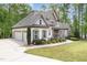 Charming house with a three car garage, beautifully landscaped yard, and welcoming front porch at 1710 Eddy Ct, Franklinton, NC 27525
