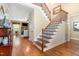 Bright foyer with hardwood floors, staircase and a view to the living room with stone fireplace at 1710 Eddy Ct, Franklinton, NC 27525