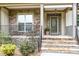 Inviting front porch with stone accents and decorative front door at 1710 Eddy Ct, Franklinton, NC 27525