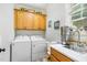 Bright laundry room features a sink, counter space, cabinets, and a washing machine and dryer at 1710 Eddy Ct, Franklinton, NC 27525