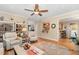 Open concept living room with hardwood floors and view to the kitchen through serving hatch at 1710 Eddy Ct, Franklinton, NC 27525