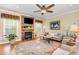 Cozy living room featuring a stone fireplace, ceiling fan, and comfortable seating at 1710 Eddy Ct, Franklinton, NC 27525