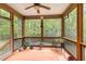 Relaxing screened porch with wood floors and views of the surrounding greenery at 1710 Eddy Ct, Franklinton, NC 27525