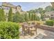 Charming backyard patio with outdoor dining set, brick accents, and lush landscaping at 19 Sangre De Cristo Dr, Durham, NC 27705