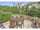 Picturesque backyard with patio dining set, vibrant flowers, and manicured greenery at 19 Sangre De Cristo Dr, Durham, NC 27705