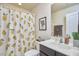 Cozy bathroom with printed shower curtain, modern vanity, and decorative mirror at 19 Sangre De Cristo Dr, Durham, NC 27705