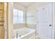 Bright bathroom featuring a large soaking tub with tiled surround and a separate shower at 19 Sangre De Cristo Dr, Durham, NC 27705