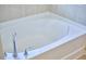 Close-up of a luxurious soaking tub with chrome fixtures and clean, minimalist design at 19 Sangre De Cristo Dr, Durham, NC 27705