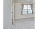 Bright bedroom featuring neutral walls, carpet, and a large window with light-filtering curtains at 19 Sangre De Cristo Dr, Durham, NC 27705