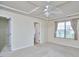 Bedroom featuring a ceiling fan, neutral walls, plush carpet, and a bright window with light-filtering curtains at 19 Sangre De Cristo Dr, Durham, NC 27705