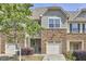 Charming townhouse with stone accents, well-maintained landscaping, and attached one car garage at 19 Sangre De Cristo Dr, Durham, NC 27705