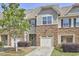 Charming townhouse with stone accents, well-maintained landscaping, and attached one car garage at 19 Sangre De Cristo Dr, Durham, NC 27705