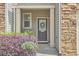 Inviting front entry with elegant wreath, potted plant, and stone accents at 19 Sangre De Cristo Dr, Durham, NC 27705
