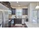 Stylish kitchen with stainless steel appliances, dark cabinetry, granite counters, and plenty of natural light at 19 Sangre De Cristo Dr, Durham, NC 27705