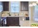 Updated kitchen with stainless steel appliances, granite countertops, dark cabinets, and ample counter space at 19 Sangre De Cristo Dr, Durham, NC 27705