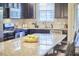 Contemporary kitchen featuring stainless steel appliances, granite countertops, dark cabinets, and a breakfast bar at 19 Sangre De Cristo Dr, Durham, NC 27705