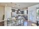Inviting living room with bar stool seating, stainless steel appliances, and hardwood floors; plenty of natural light at 19 Sangre De Cristo Dr, Durham, NC 27705
