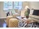 Inviting living room featuring a cozy armchair, patterned rug, and a window with natural light at 19 Sangre De Cristo Dr, Durham, NC 27705