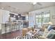 Sun-filled living room with modern decor, hardwood floors, and access to a kitchen for seamless entertaining at 19 Sangre De Cristo Dr, Durham, NC 27705